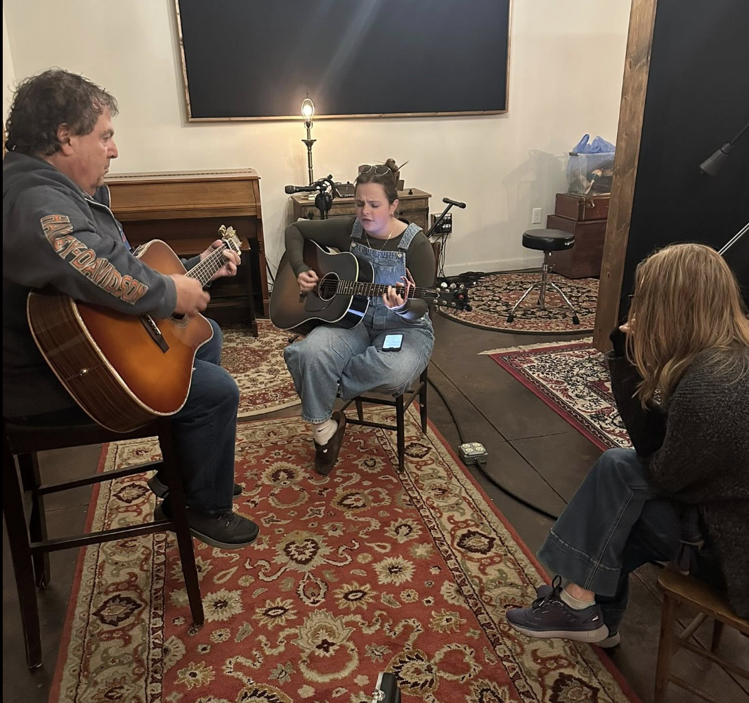Mike coaching a participant playing guitar at a live intensive