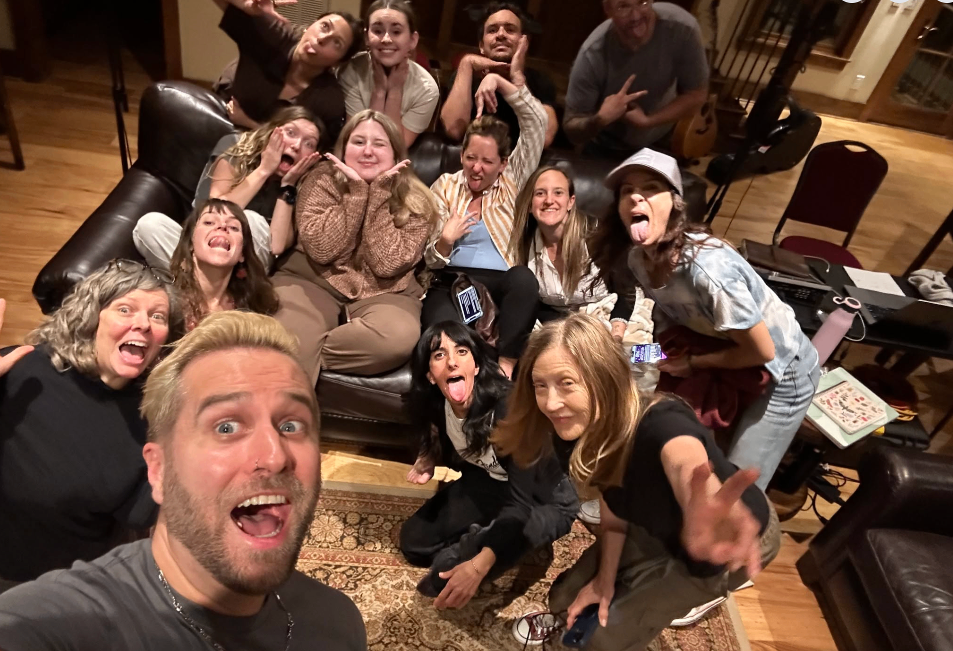 Group of attendees laughing together at the end of an intensive